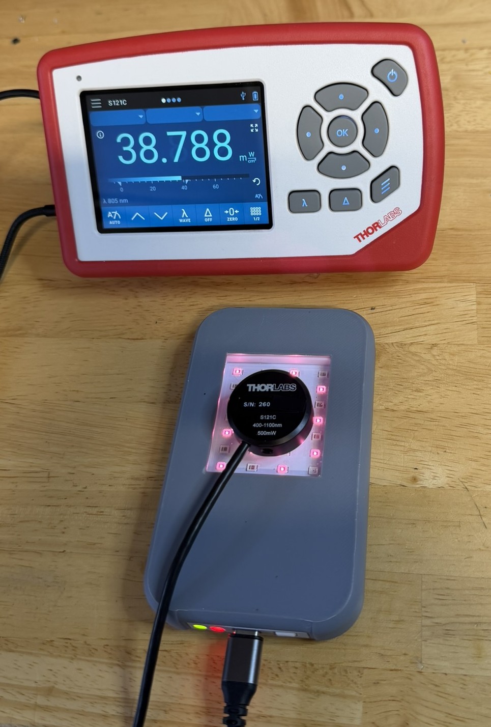 Rejuvulite device under measurement with Thorlabs S121C sensor and PM100D meter reading 38.788 mW/cm²